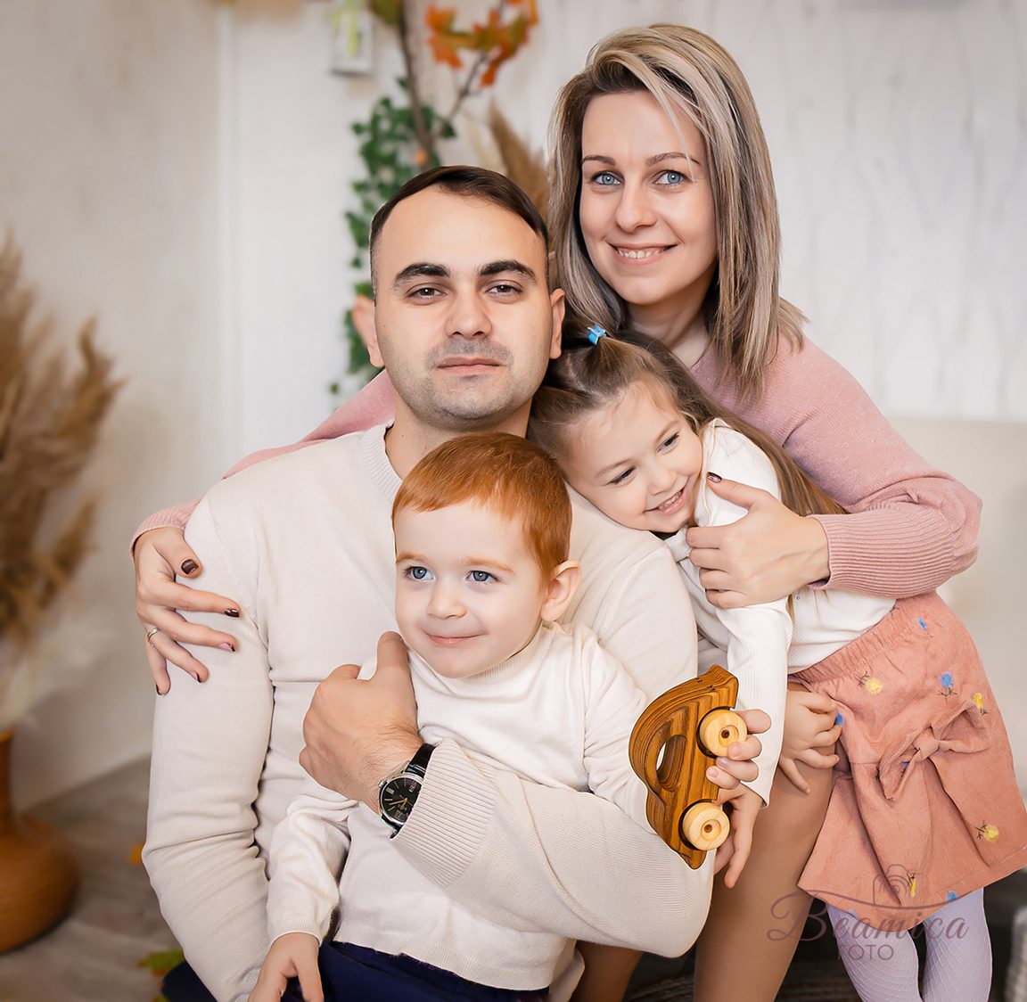 Családi pillanat, ölelés, játékosság egy szülinapi fotózáson, pasztell árnyalatokkal, természetes fényben, lifestyle stílusban.